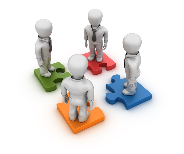 Rendering of four people each standing on a different color puzzle piece